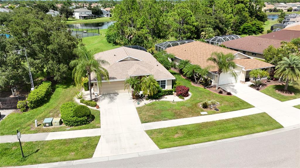 An aerial view shows two suburban houses with driveways, lawns, and palm trees — 1520 SCARLETT AVENUE, NORTH PORT, FL