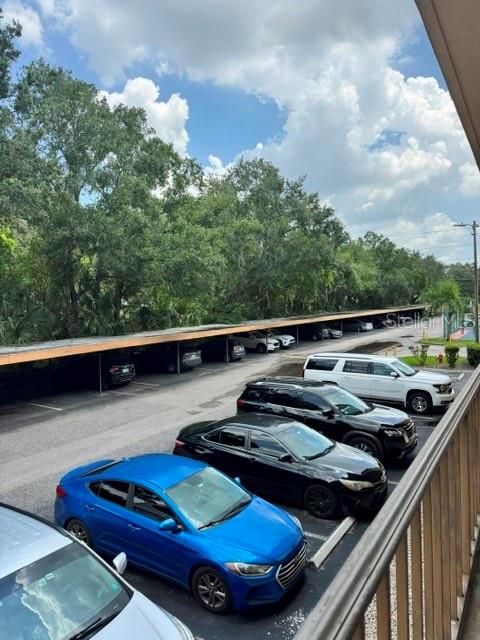 An elevated view of a parking lot with covered spaces and several parked cars — 5820 N CHURCH AVENUE UNIT 256, TAMPA, FL