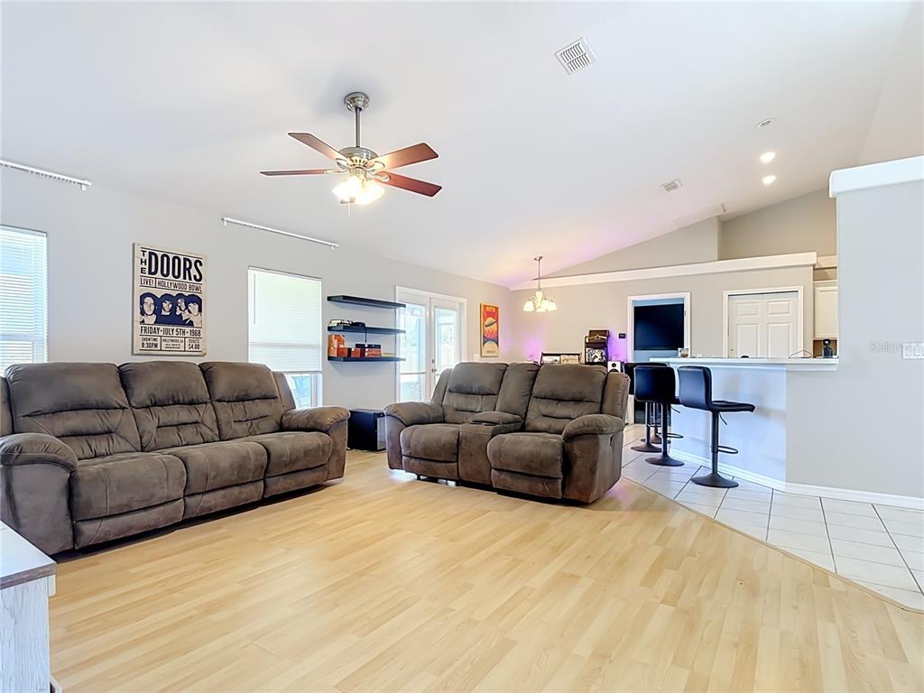An entryway features a white front door with a sidelight, arched windows, and tiled flooring — 3600 YELLOW BIRD COURT, ST CLOUD, FL