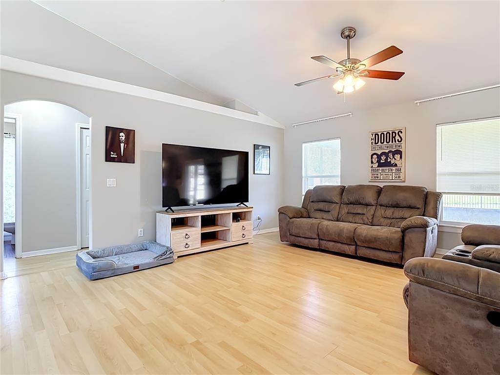 A dining area features a glass-topped table, upholstered chairs, a pendant light, and tile flooring — 3600 YELLOW BIRD COURT, ST CLOUD, FL