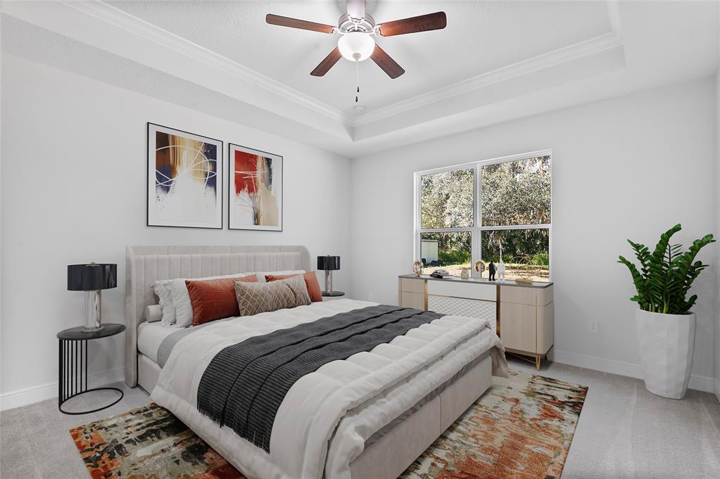 A bedroom features a tray ceiling, a bed with orange pillows, and a large window — 335 MILLER ROAD, SANFORD, FL