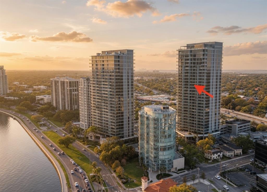 A modern high-rise balcony features gray tile flooring and a glass railing overlooking a city — 3015 S YSABELLA AVENUE UNIT 2003, TAMPA, FL