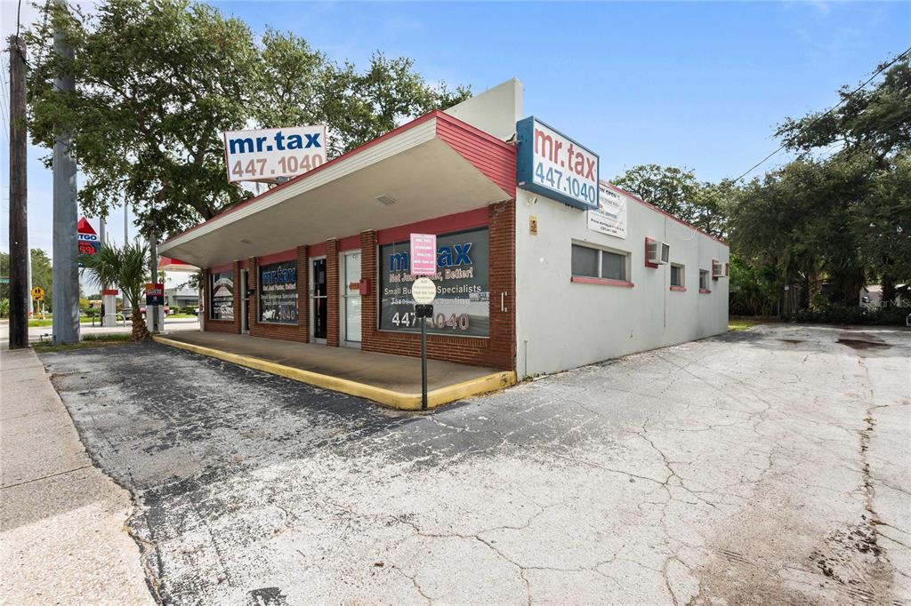 A single-story commercial building with a brick facade and a flat roof, labeled Mr. Tax — 1311 S MISSOURI AVENUE, CLEARWATER, FL