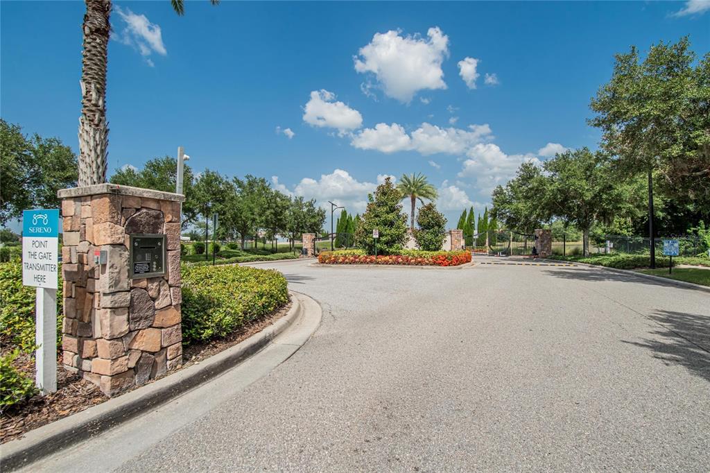 A stone pillar with a gate transmitter sign stands at the entrance to a community — 16441 TREASURE POINT DRIVE, WIMAUMA, FL