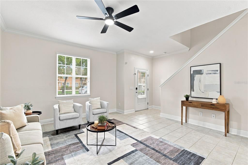 A living room features light tile floors, a ceiling fan, and a geometric area rug — 829 BELLES FERRY LOOP, SANFORD, FL
