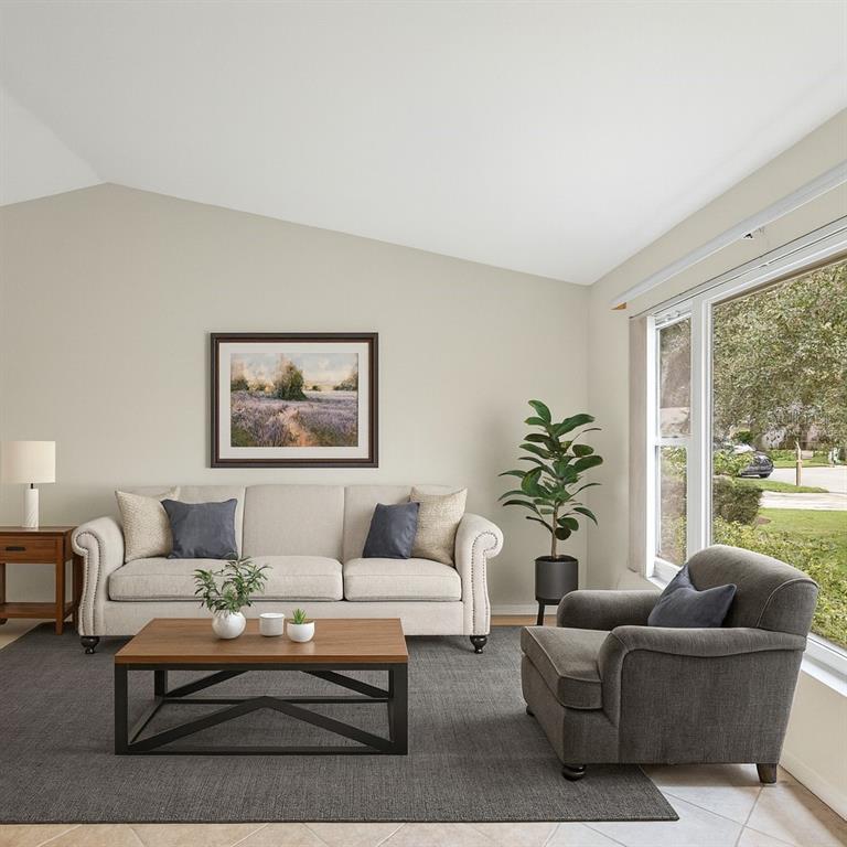 A living room features a beige sofa, a gray armchair, and a wooden coffee table — 12595 93RD WAY, LARGO, FL