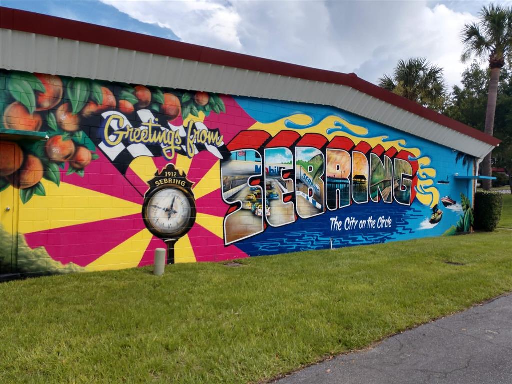 A colorful mural on the exterior wall of a building depicts the city of Sebring — 9408 ELDER BERRY COURT, SEBRING, FL