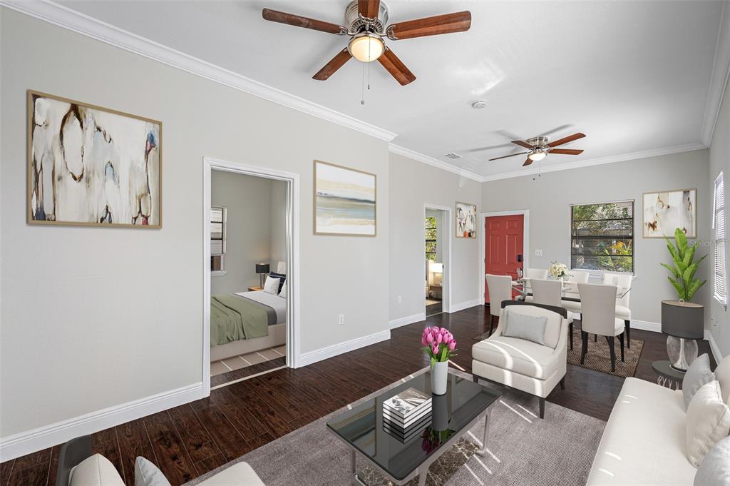 A living room and dining area with dark wood floors, ceiling fans, and white walls — 2118 W PALMETTO STREET, TAMPA, FL