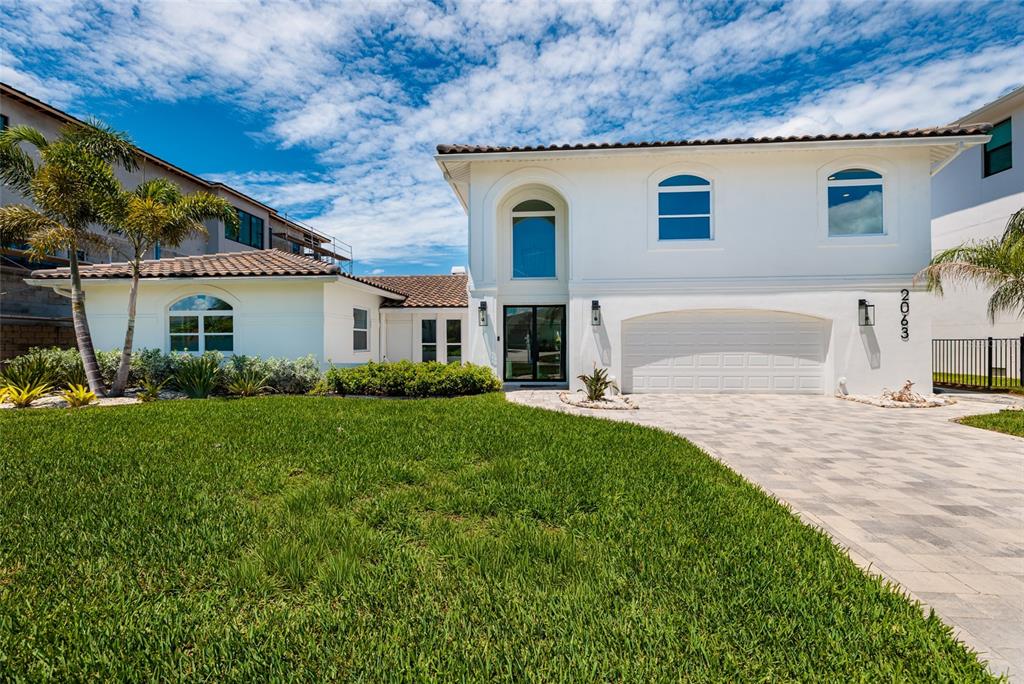 An aerial view shows a waterfront house with a boat dock on a canal — 2063 ILLINOIS AVENUE NE, ST PETERSBURG, FL