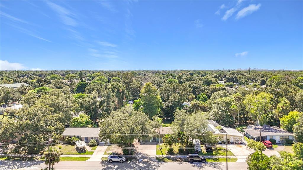 A single-story house with a light green exterior, a gray garage door, and a front lawn — 2212 VINSON AVENUE, SARASOTA, FL