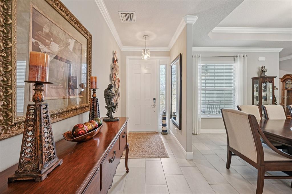 A single-story house with a light green exterior, a brick driveway, and a two-car garage — 3955 OAK HOLLOW AVENUE, VERO BEACH, FL