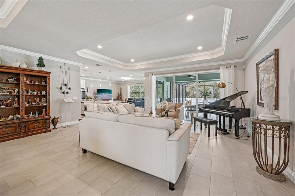A foyer with a wooden console table leads to a dining area with tiled floors — 3955 OAK HOLLOW AVENUE, VERO BEACH, FL
