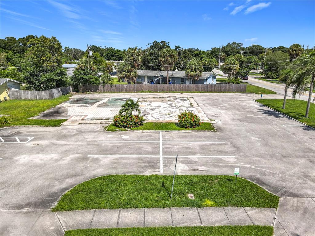 An aerial view shows a vacant paved lot with a concrete foundation and landscaping — 810 21ST STREET, VERO BEACH, FL