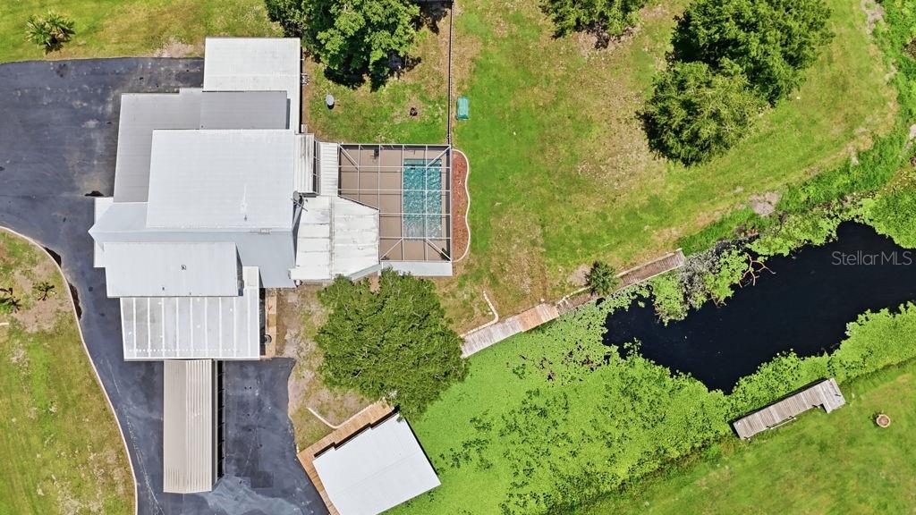 A two-story, light blue house with a prominent A-frame roof and an attached garage — 220 BRANDY COURT, DELTONA, FL