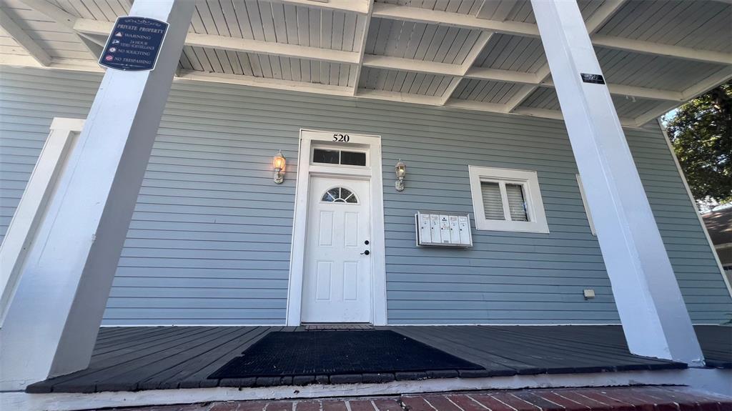 A light blue house exterior features a white front door, porch, and wall-mounted mailboxes — 520 S BROADWAY AVENUE, BARTOW, FL