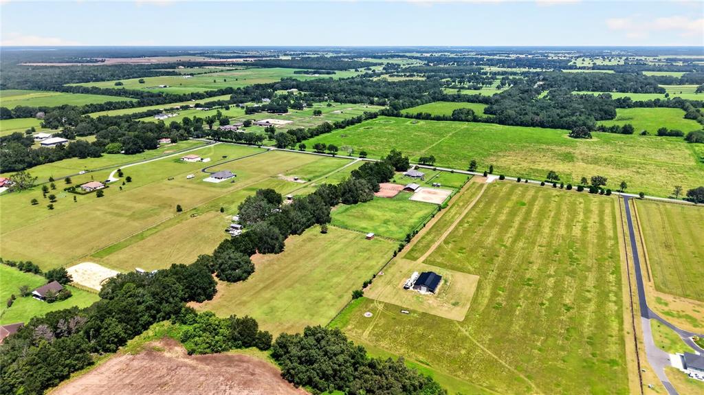 An aerial view shows a large rural property with multiple pastures, buildings, and tree clusters — 20462 SW 36TH STREET, DUNNELLON, FL