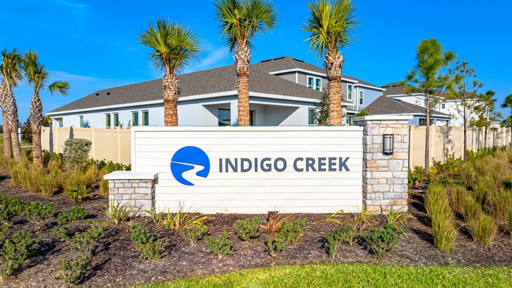 A white sign with the Indigo Creek logo stands in front of a residential building — 868 STEEL DRIVE, APOLLO BEACH, FL