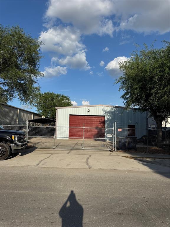 An industrial warehouse space features a large stone cutting machine and a parked forklift — 4825 N LAUBER WAY, TAMPA, FL
