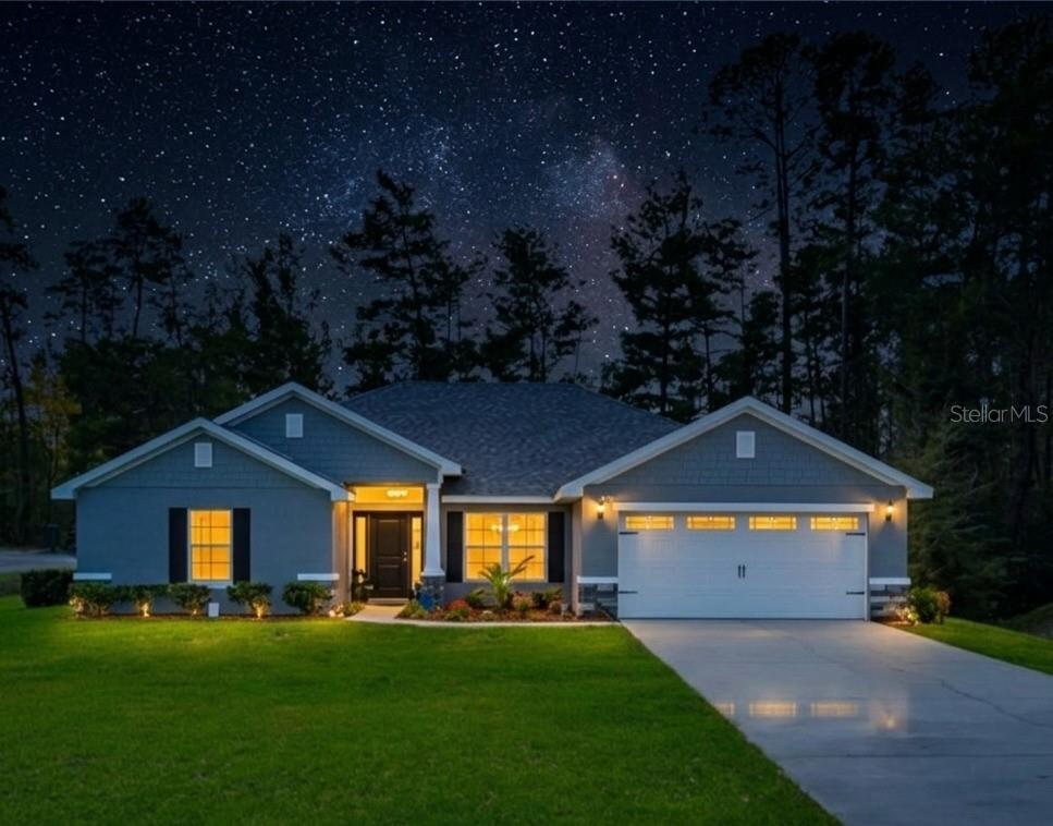 A gray single-story house features a stone-accented entryway, dark shutters, and a landscaped front yard — 47 VILLAGE CENTER DRIVE, HOMOSASSA, FL