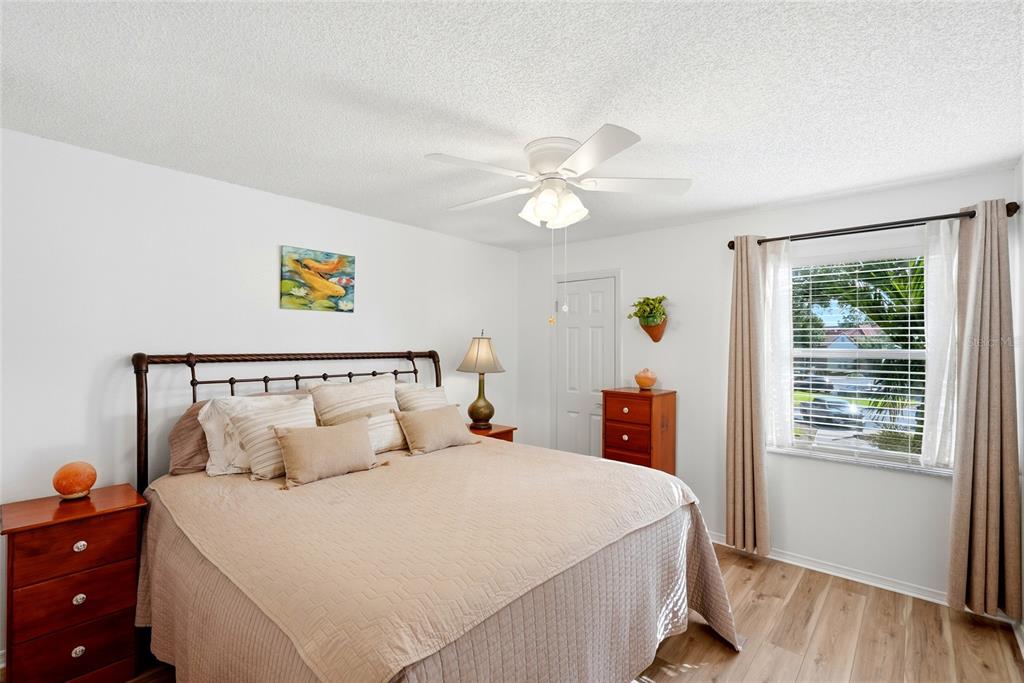A kitchen with white cabinets, stainless steel appliances, and a breakfast bar with wooden stools — 2400 FEATHER SOUND DRIVE UNIT 427, CLEARWATER, FL