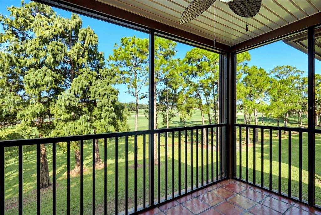 A kitchen with stainless steel appliances, white cabinets, and a breakfast bar overlooking the living area — 2400 FEATHER SOUND DRIVE UNIT 427, CLEARWATER, FL