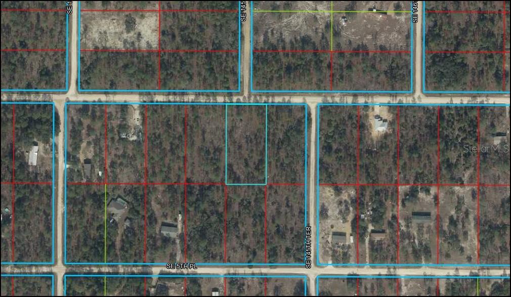 This is an aerial map showing a vacant rectangular lot outlined in blue — SE 4TH STREET, WILLISTON, FL