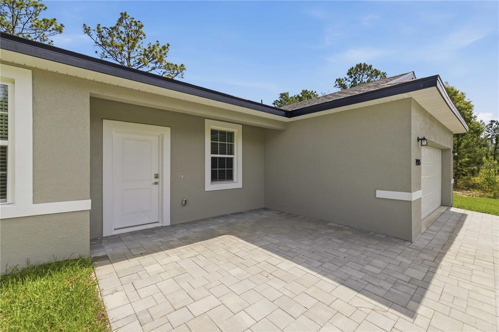 This is a 3D floor plan rendering of a single-story house with a two-car garage — 1985 W CORRINE STREET, DUNNELLON, FL