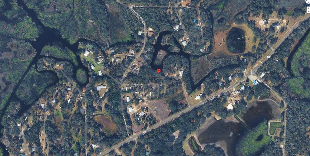 This is an aerial map view showing a residential area with roads, trees, and water — 7089 E LEANING OAK DRIVE, INVERNESS, FL