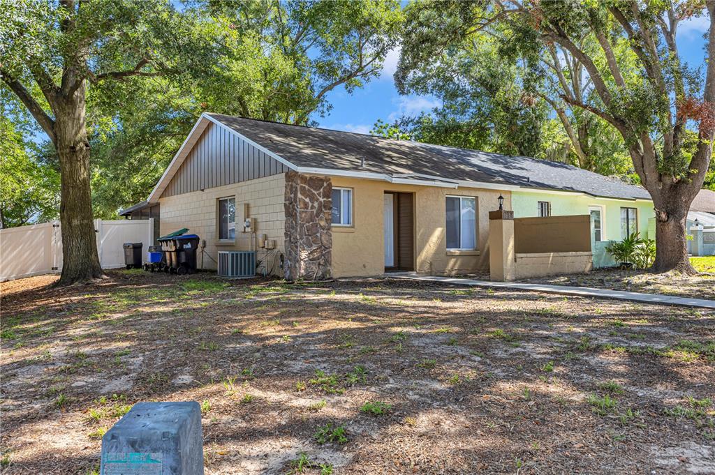 A single-story house with a stone accent wall, tan siding, and a large front yard — 3675 WESTLAND COURT, ORLANDO, FL