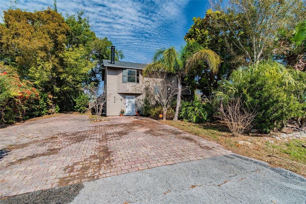 A two-story house with a brick paver driveway and a palm tree in the front yard — 532 45TH STREET COURT W, PALMETTO, FL