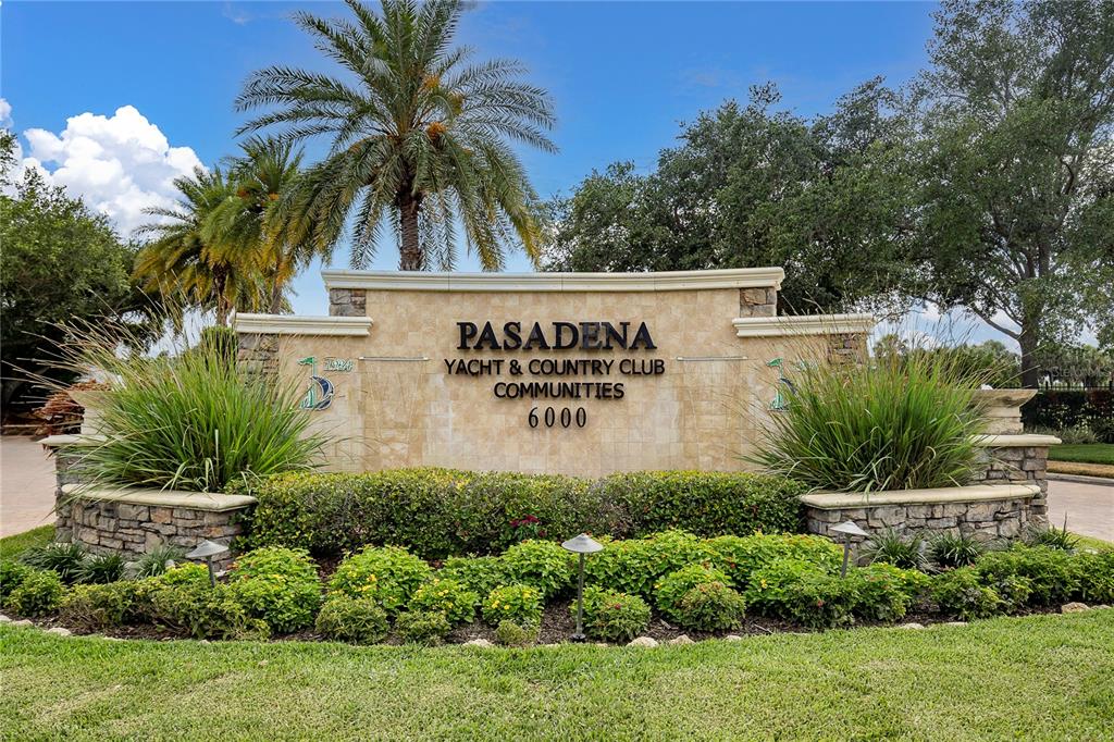 An aerial view shows two tall residential towers connected by a parking structure near water — 5950 PELICAN BAY PLAZA S UNIT 601, GULFPORT, FL