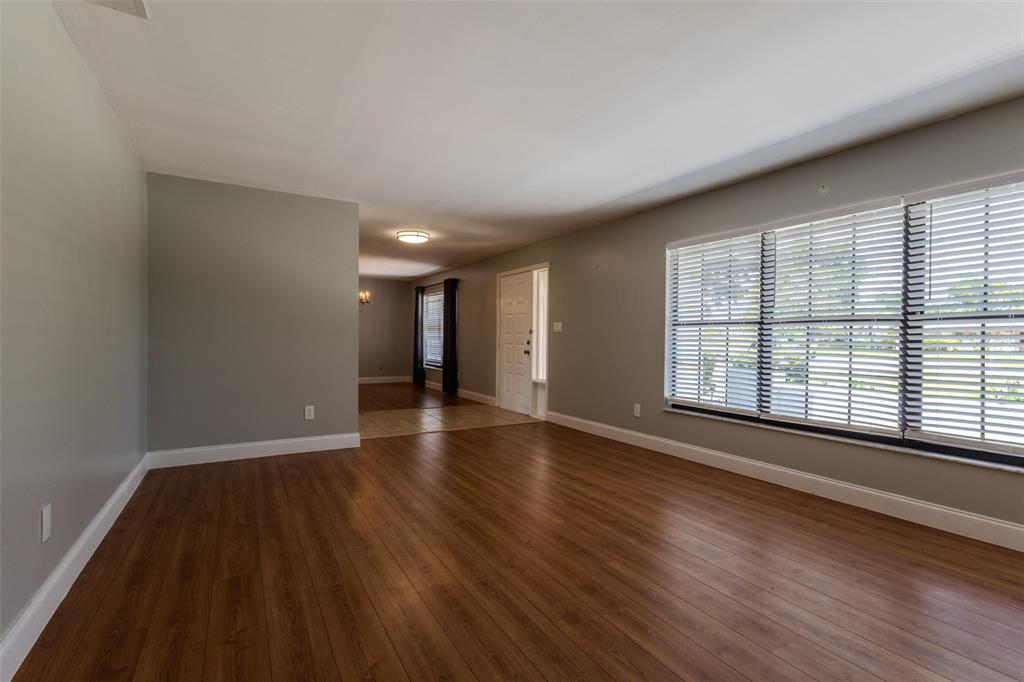 A single-story house with a metal roof, a two-car garage, and a concrete driveway — 1861 CROWLEY CIRCLE E, LONGWOOD, FL