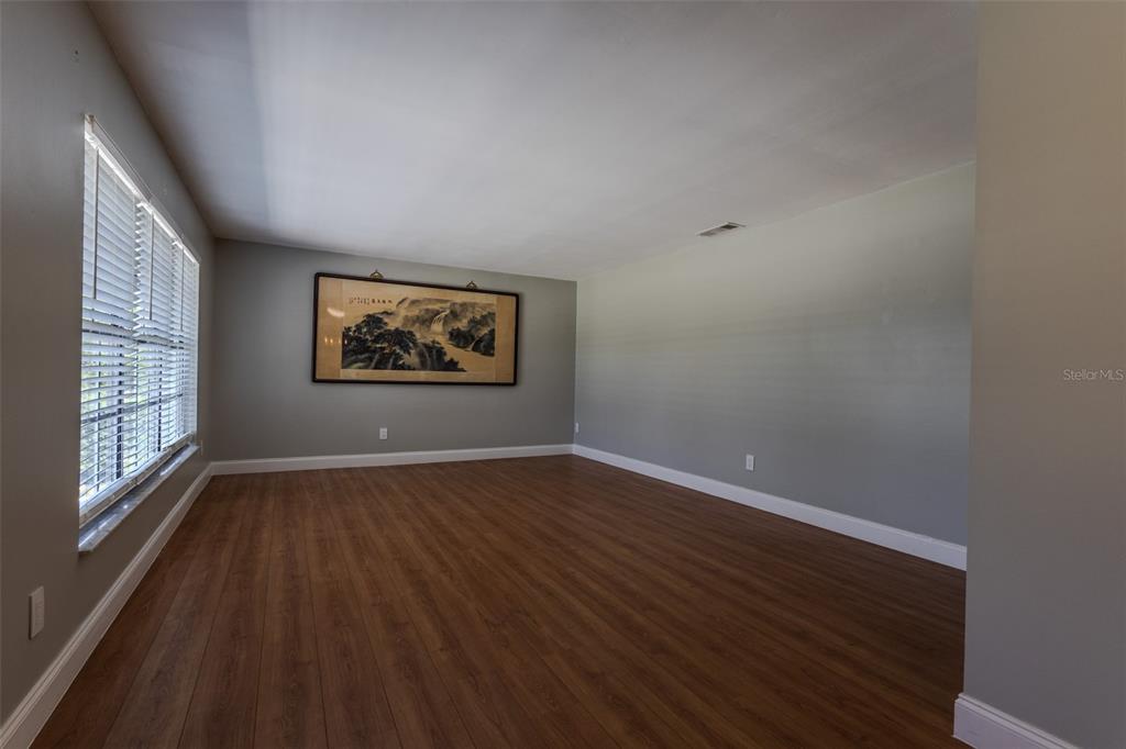 A single-story house with a metal roof and a two-car garage sits on a lawn — 1861 CROWLEY CIRCLE E, LONGWOOD, FL