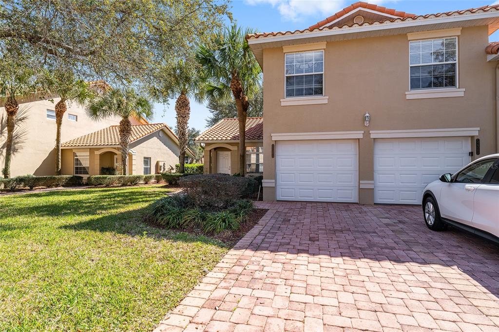 A two-story house with a two-car garage and a brick paver driveway — 5427 COMPASS POINT UNIT 1, OXFORD, FL