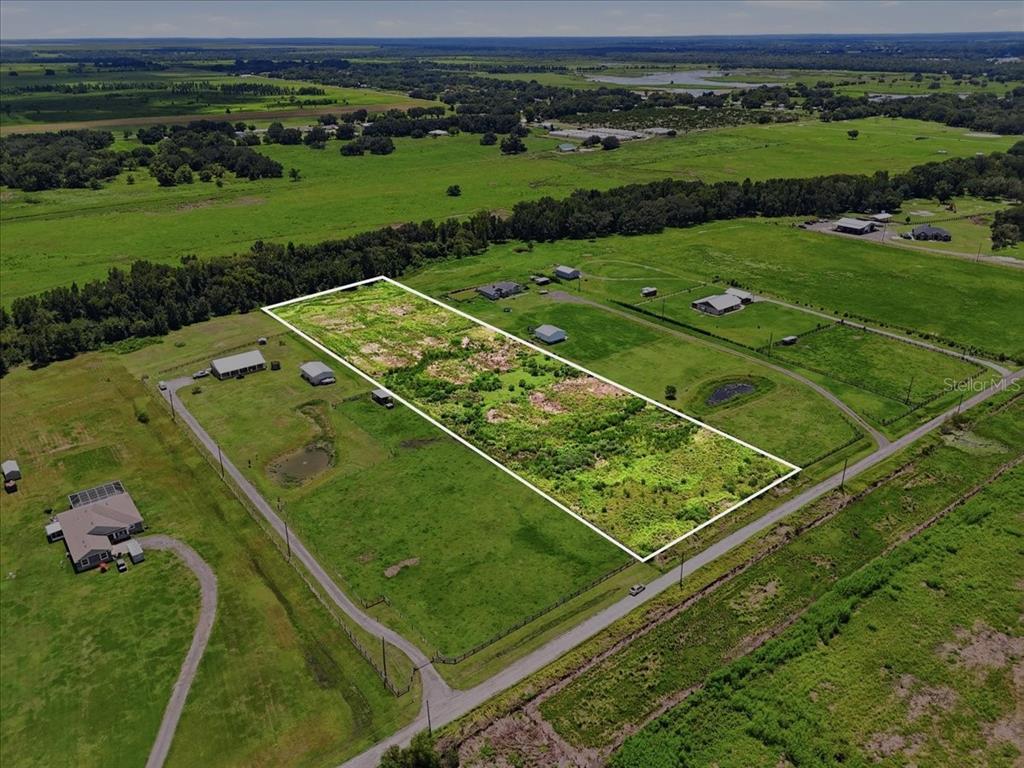 An aerial view shows a rectangular, undeveloped plot of land outlined in white — 737 BROOKE ROAD, FORT MEADE, FL