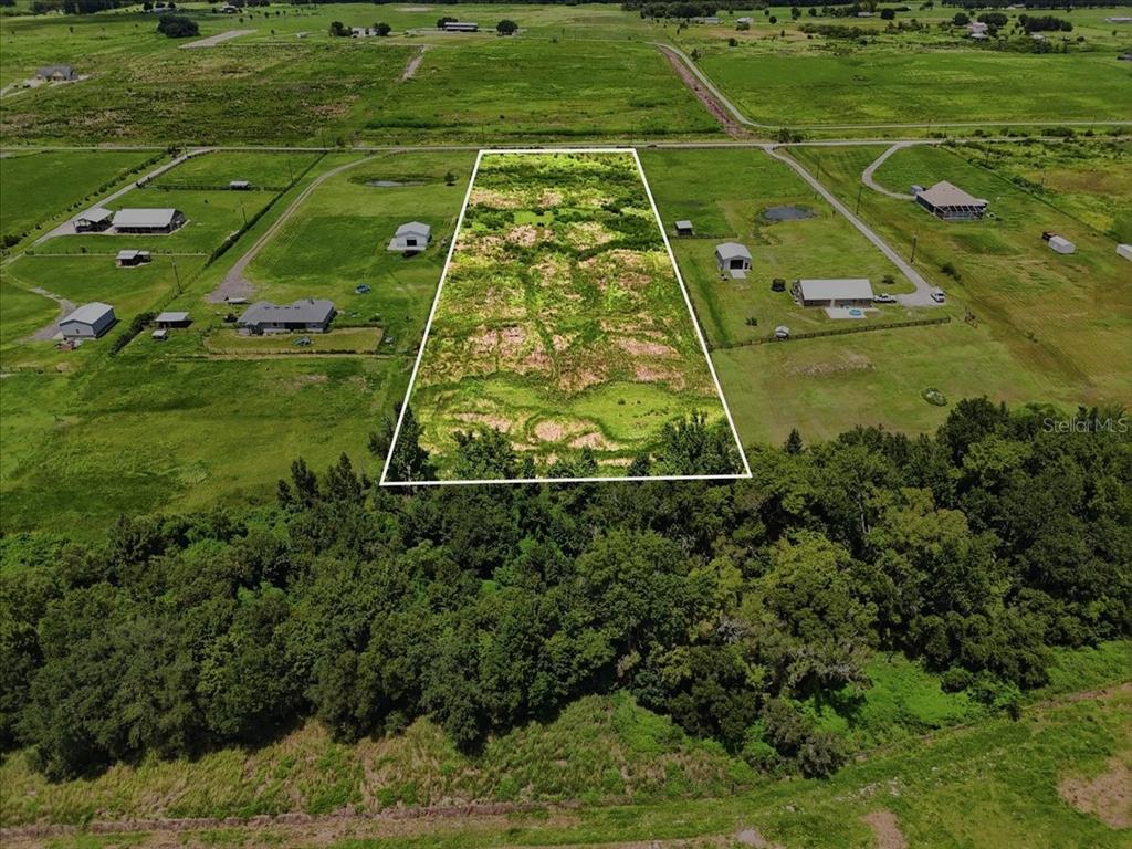 An aerial view shows a rectangular, undeveloped plot of land outlined in white — 737 BROOKE ROAD, FORT MEADE, FL