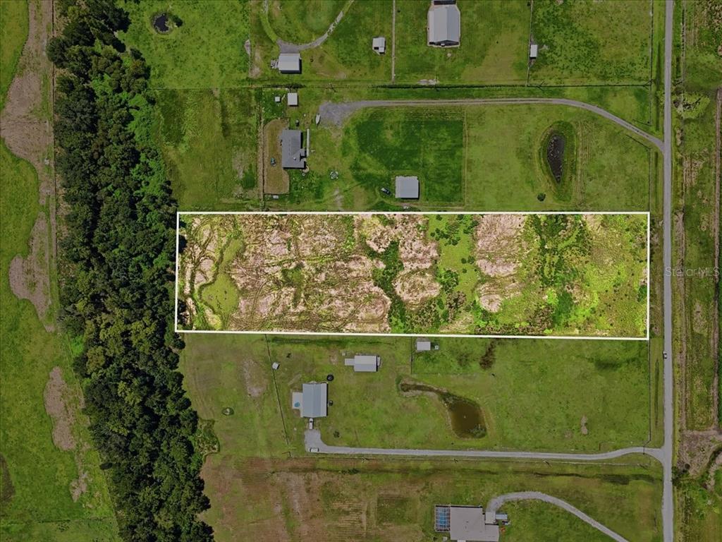 An aerial view shows a rectangular plot of land outlined in white within a rural area — 737 BROOKE ROAD, FORT MEADE, FL