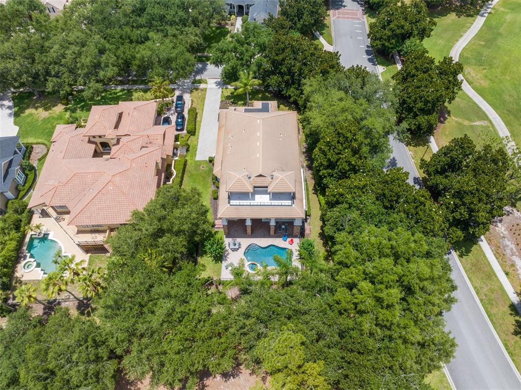 An aerial view shows two adjacent houses with swimming pools and surrounding trees — 6288 BLAKEFORD DRIVE, WINDERMERE, FL