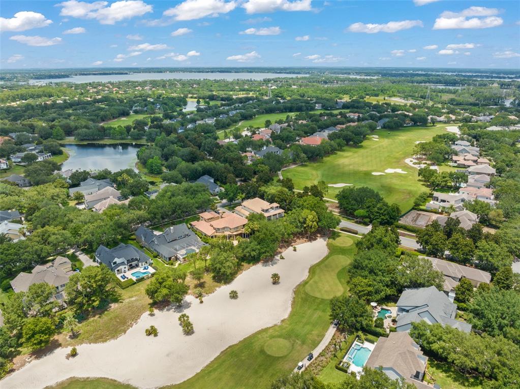 Aerial view of a residential neighborhood featuring houses, swimming pools, and a golf course — 6288 BLAKEFORD DRIVE, WINDERMERE, FL
