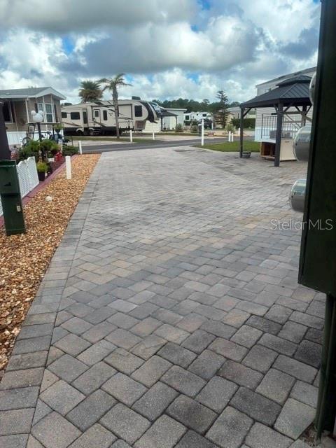 A paved driveway leads toward a gazebo and a parked recreational vehicle — 2512 MAGNOLIA STREET, CLERMONT, FL