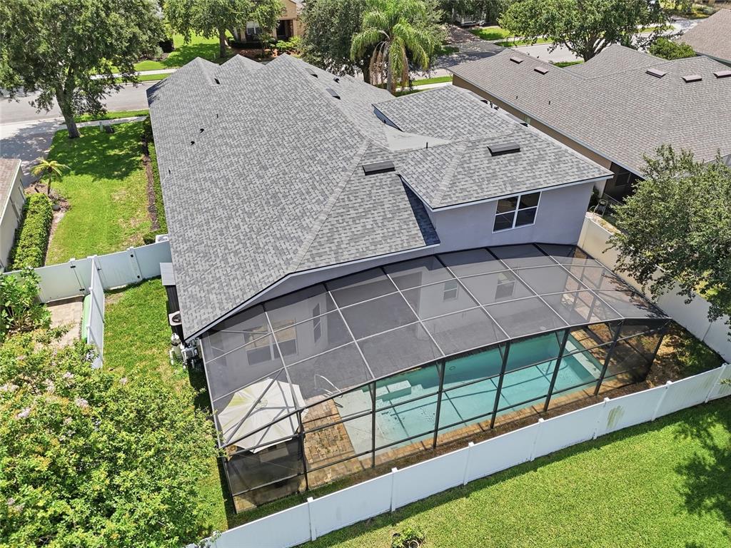 An aerial view of a house with a shingled roof and a screened-in swimming pool — 1830 BURDOCK DRIVE, WINTER GARDEN, FL