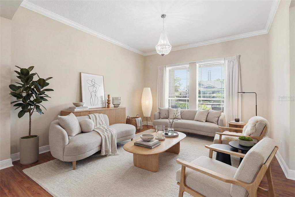 A bright living room features two beige sofas, two wooden armchairs, and a coffee table — 1830 BURDOCK DRIVE, WINTER GARDEN, FL