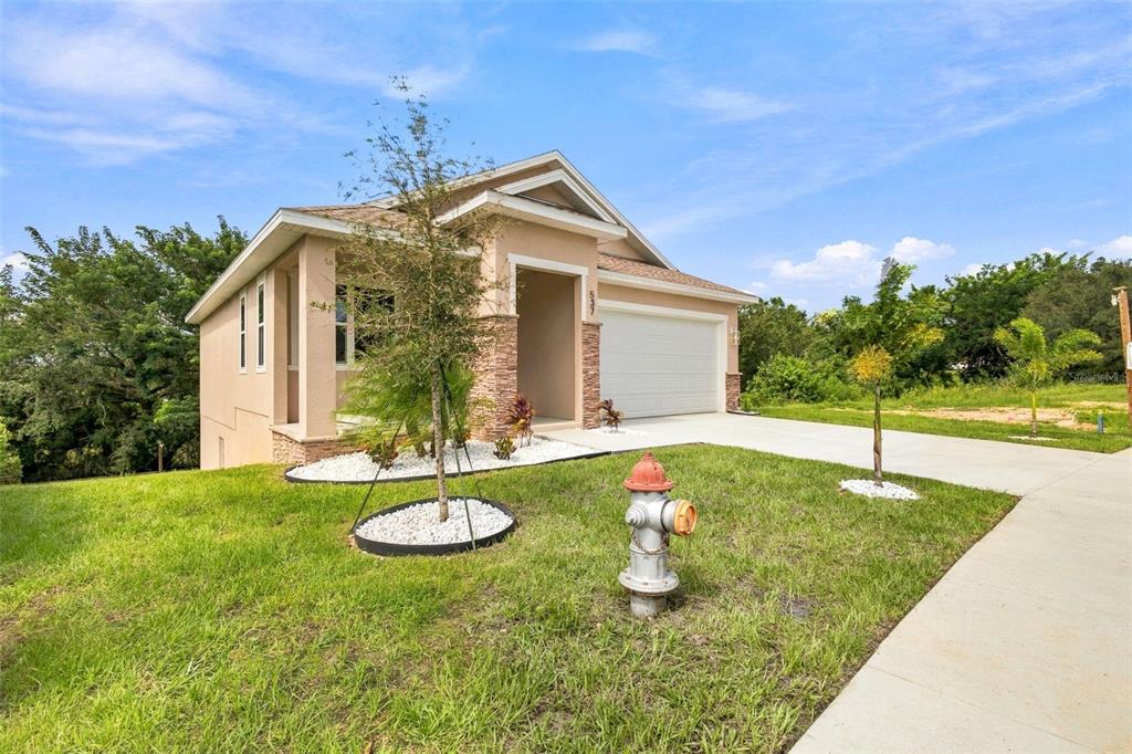 This is a rendering of the exterior of a two-story house with a covered patio — 537 PINELOCH DRIVE, HAINES CITY, FL