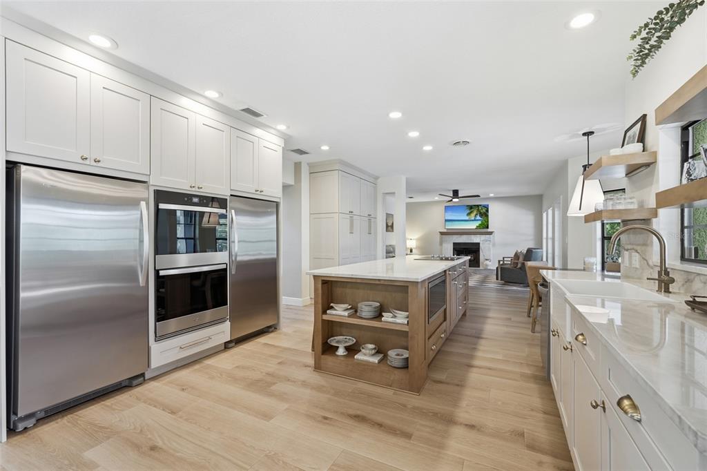 A two-story house with a white exterior, dark roof, two-car garage, and a palm tree — 6000 CLEVELAND DRIVE, PUNTA GORDA, FL