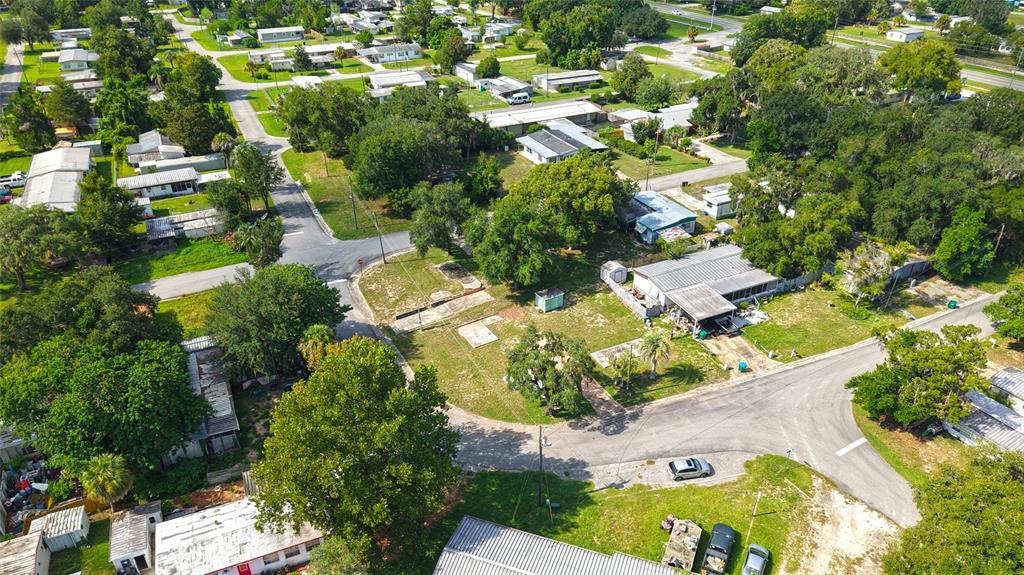 An aerial view shows a residential neighborhood with several mobile homes and a vacant lot — 3535 E EAGLE TRAIL, HERNANDO, FL