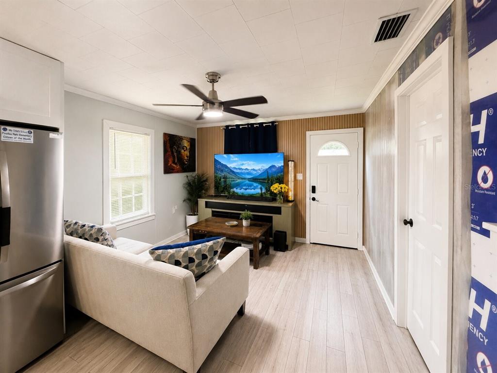 A modern kitchen features white cabinets, stainless steel appliances, and a light-colored countertop — 217 50TH TER N, ST PETERSBURG, FL