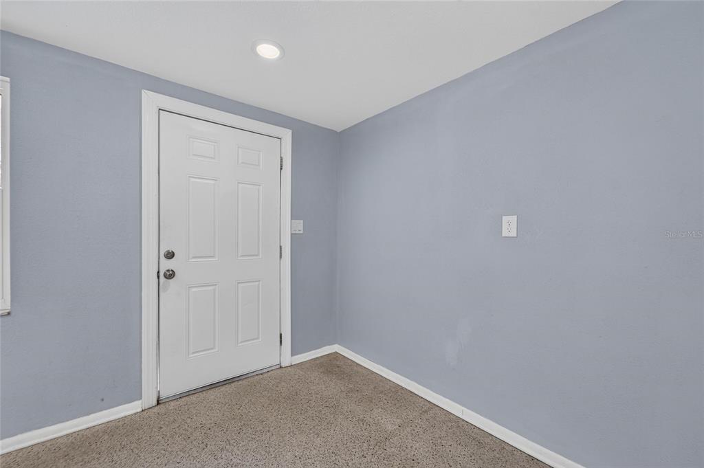 A room with light blue walls, beige carpeting, a white door, and a recessed ceiling light — 506 SHAMROCK ROAD, BRANDON, FL