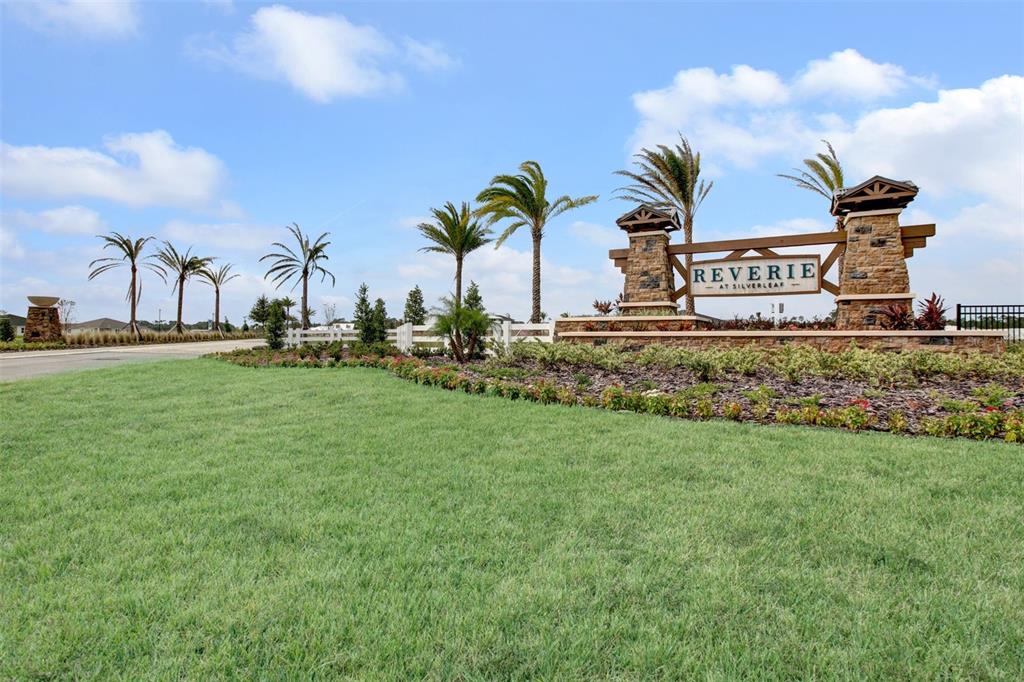 A stone monument sign for Reverie at Silverleaf sits in a landscaped grassy entrance — 226 DAY DREAM DRIVE, ST AUGUSTINE, FL