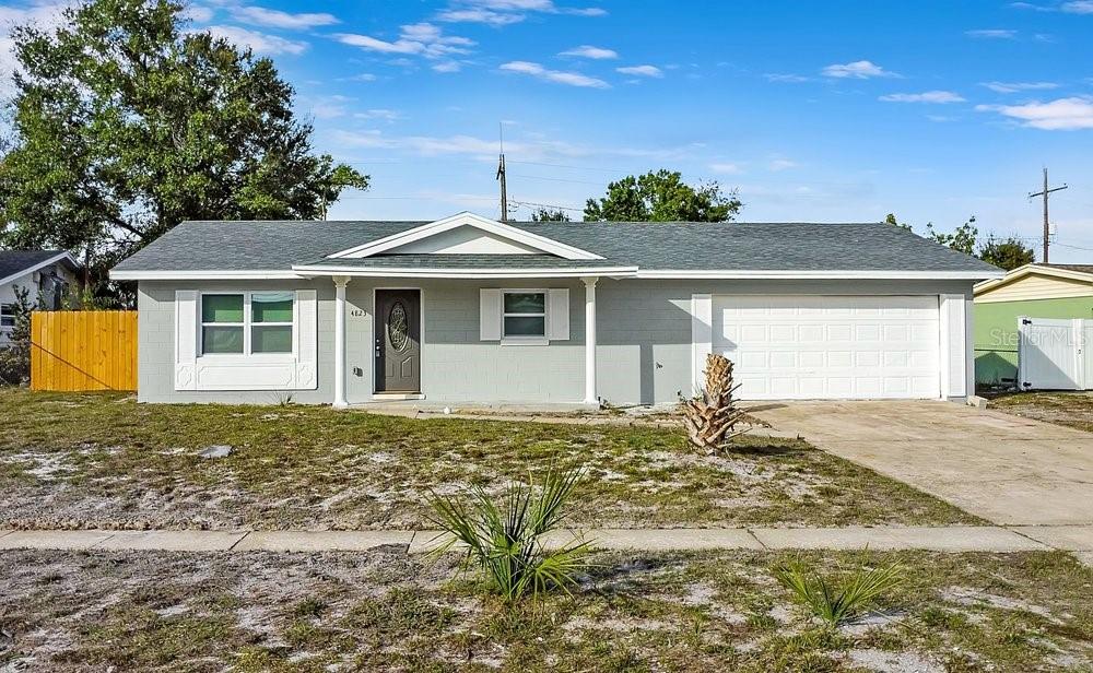 A single-story house with a gray exterior, white trim, a garage, and a front porch — 4823 KATHY JO TERRACE, ORLANDO, FL