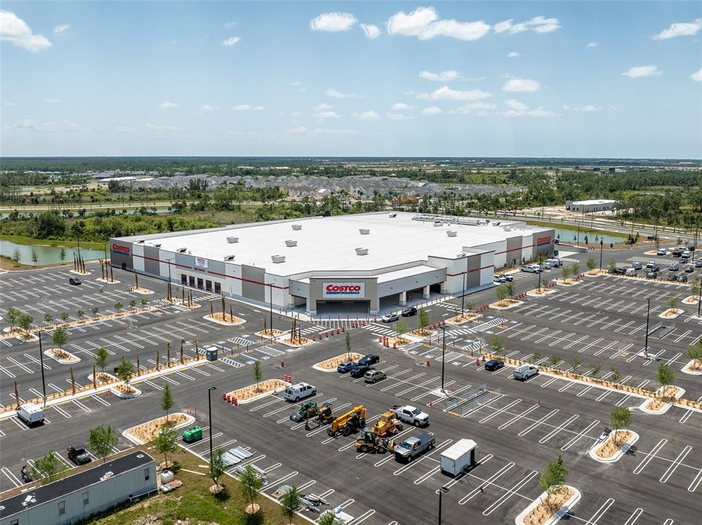An aerial view shows a large Costco warehouse building surrounded by a vast parking lot — LOTS 19 & 20 SABRINA TERRACE, NORTH PORT, FL
